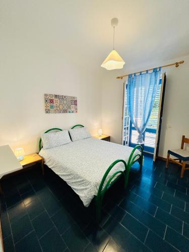 a bedroom with a bed and a window at Villa Teti - Sicilia in Campofelice di Roccella