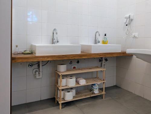 a bathroom with two sinks and two mirrors at inScialla Hostel in Trapani