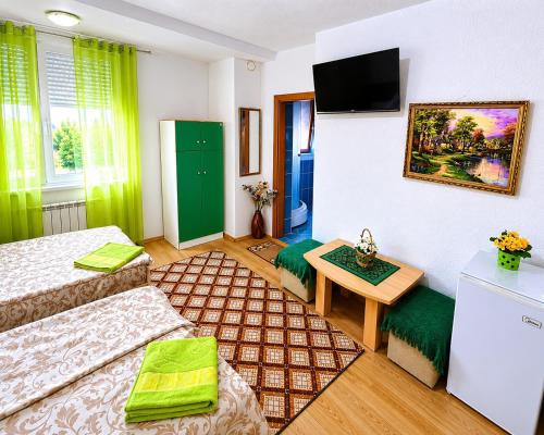 a small room with two beds and a table at Villa Flora in Ohrid