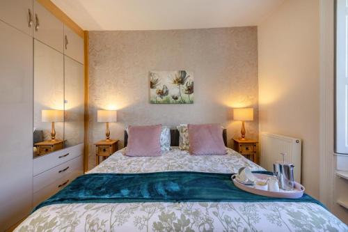 a bedroom with a large bed with two lamps at 2 Bed in Eyemouth oc-77427 in Ayton