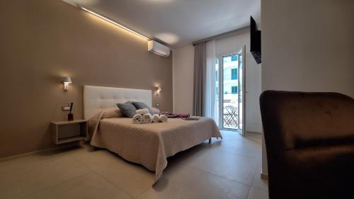 a bedroom with a bed with two stuffed animals on it at Venti del Sud in Vieste