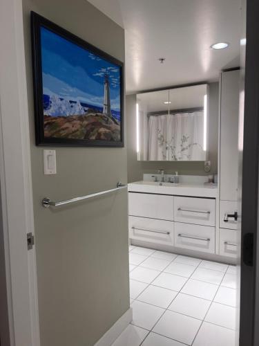 a bathroom with a sink and a mirror at Vancouver Condo-Park-Walk to Stadium-Sleeps 4 in Vancouver
