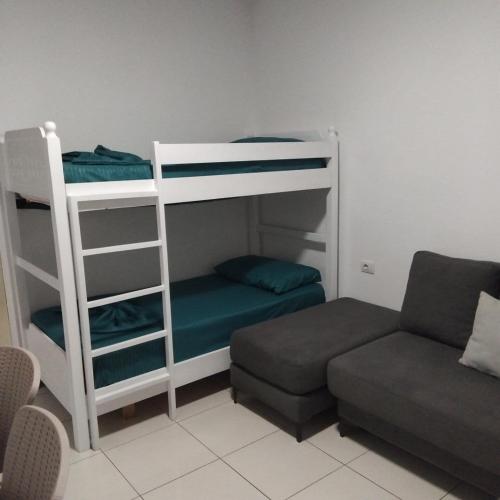 a living room with bunk beds and a couch at Private Rooms in Velipojë