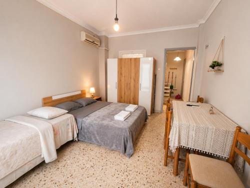 a bedroom with two beds and a table in it at Karma Seaside Apartment in Perea