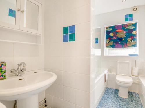 a white bathroom with a sink and a toilet at 2 Bed in Monmouth oc-93650 in Trelleck