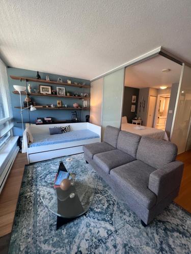 a living room with a couch and a bed at Vancouver Condo-Park-Walk to Stadium-Sleeps 4 in Vancouver