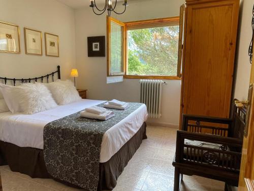 a bedroom with a bed with two towels on it at Tena Biescas Tourist Home in Biescas
