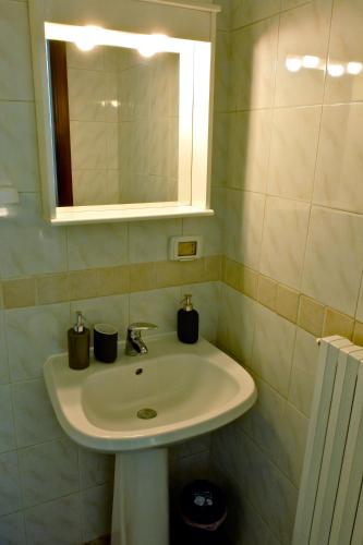 a bathroom with a sink and a mirror at Alla Cattedrale - Locazione Turistica in Sulmona