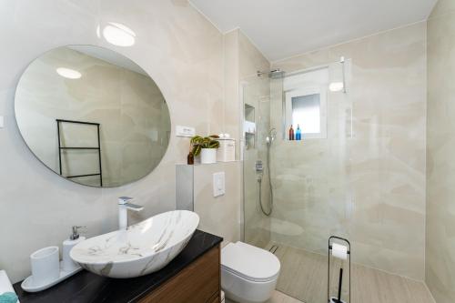 a white bathroom with a sink and a mirror at Sky Lounge & More - Rooftop Wellness & Gym in Zadar