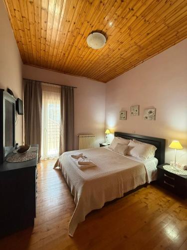 a bedroom with a large bed with a wooden ceiling at S&E home in Nikiana