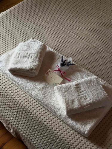 a pair of towels sitting on top of a bed at S&E home in Nikiana