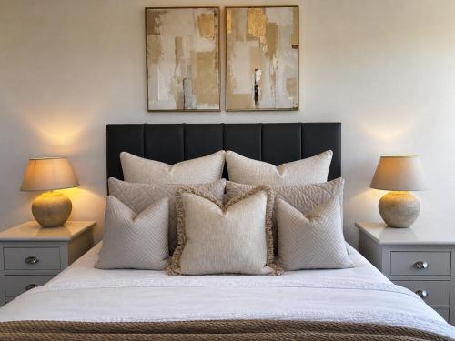 a bedroom with a large bed with white pillows at Holdsworth House Apartments in Killingbeck