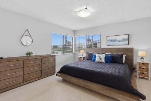 a bedroom with a bed and a large window at Stunning Sunset Scenes in Wesley Chapel