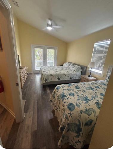 a bedroom with two beds and a window at Charming Key West Rental in Key West