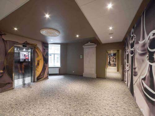 a large room with paintings on the walls at Ibis Riga Centre in Riga