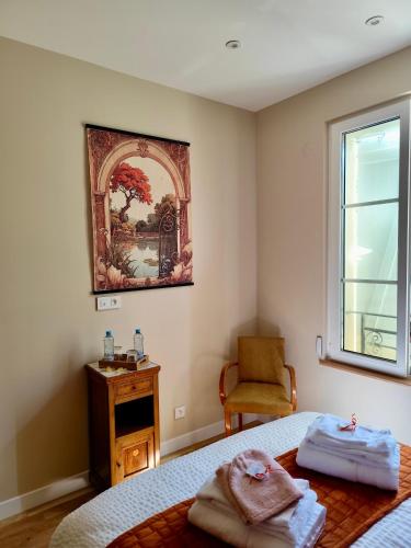 a bedroom with a bed and a window and a chair at Domaine de la Brême in Bréménil