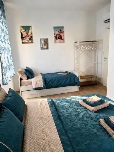 a bedroom with two beds and a couch at Sea Breeze Suites in Livorno