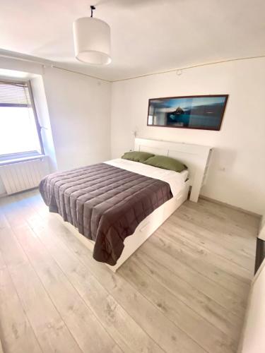 a bedroom with a bed and a tv on the wall at Casa Alice in Muggia