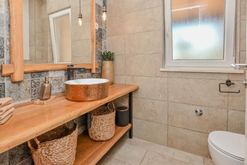 a bathroom with a sink and a toilet at Casa di Marko-NEW MODERN RUSTIC HOUSE with pool AND SPACIOUS GARDEN! in Privlaka