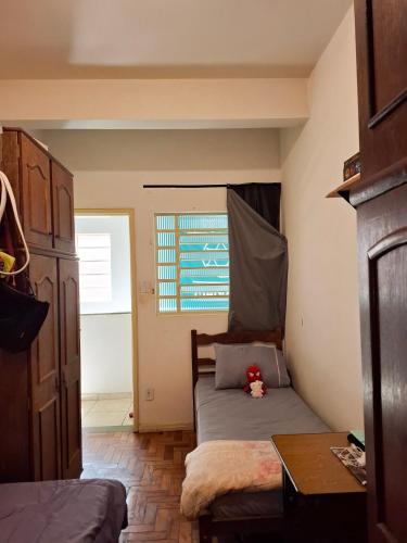 a small bedroom with a bed and a window at República Mandala - Quarto duplo 2 in Ouro Preto