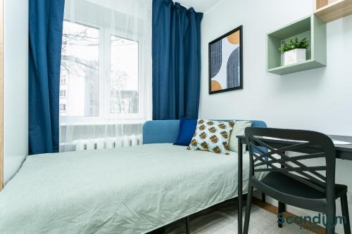 a small bedroom with a bed and a desk at Sõle Studios by RevalHome in Tallinn