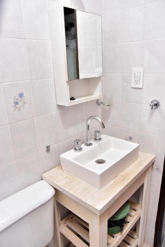 a bathroom with a sink and a toilet and a tub at Las Magnolias in Embalse