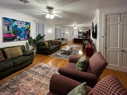 a living room with two couches and a living room with a ceiling at Spacious Napoleon Ave Condo in New Orleans