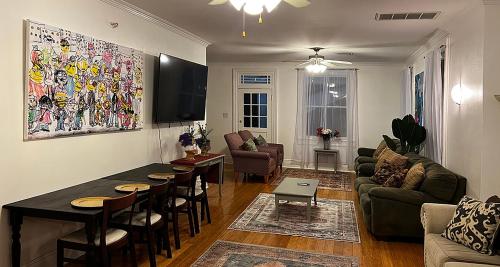 a living room with a couch and a table at Spacious Napoleon Ave Condo in New Orleans