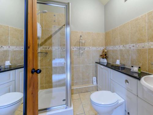 a bathroom with a shower and a toilet and a sink at 1 Bed in York oc-83265 in High Catton