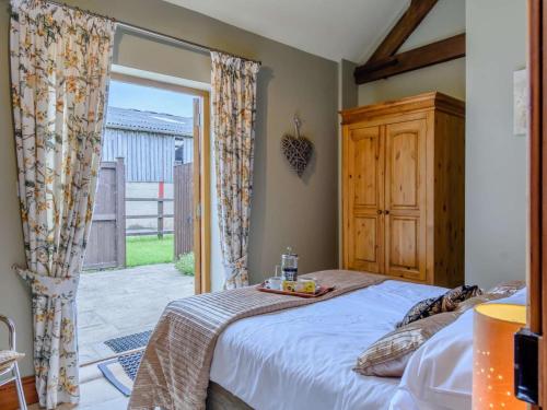 a bedroom with a bed and a large window at 1 Bed in York oc-83265 in High Catton