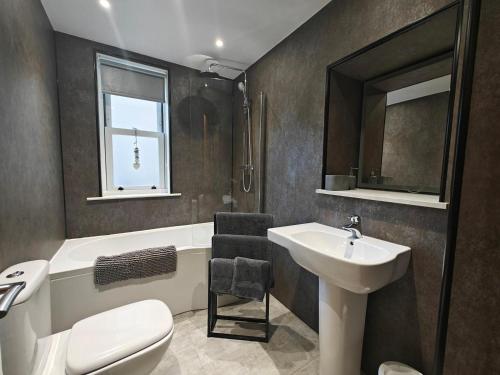 a bathroom with a sink and a toilet and a tub at 1 Bed in Duns oc-83140 in Duns