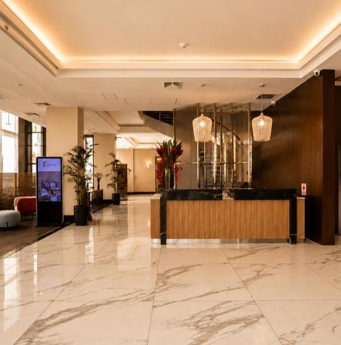 a lobby with a reception desk in a building at Sol de Oro Hotel & Suites in Lima