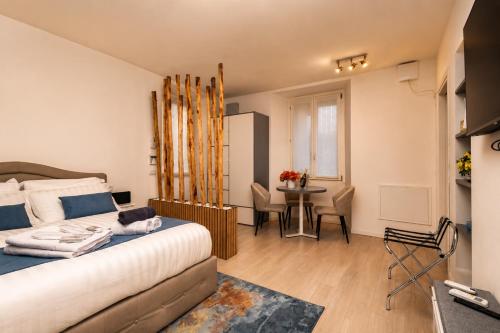 a bedroom with a bed and a table in a room at 2 passi dal lago, Como Lake in Abbadia Lariana