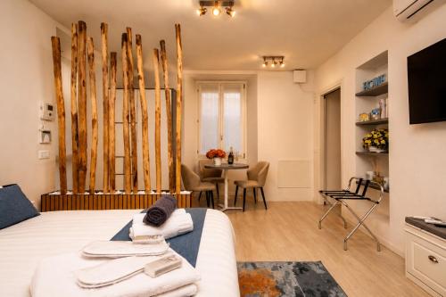 a bedroom with a bed and a table with chairs at 2 passi dal lago, Como Lake in Abbadia Lariana