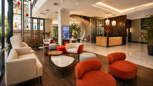 a lobby with couches and chairs in a building at Sol de Oro Hotel & Suites in Lima