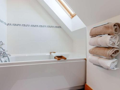 a bathroom with a sink and a tub and towels at 2 Bed in Perth oc-86059 in Forgandenny