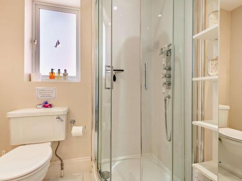 a bathroom with a shower and a toilet at 3 Bed in Brockenhurst oc-nfl92 in Brockenhurst