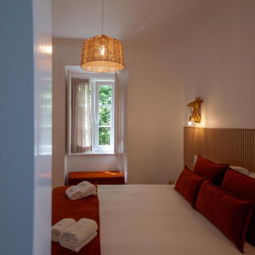 a bedroom with a bed and a window at Santos da Vila in Sintra