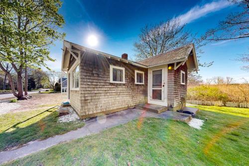 a small house on a grassy yard with a house at The Pinkletink in Oak Bluffs