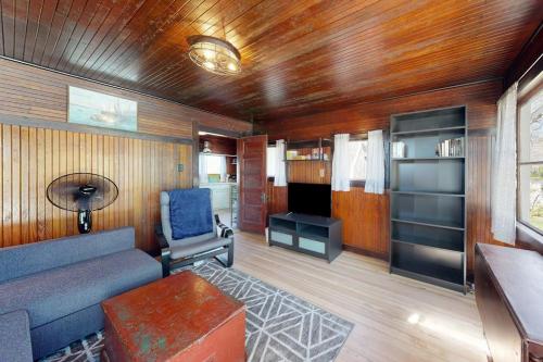 a living room with a couch and a chair at The Pinkletink in Oak Bluffs