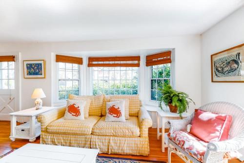 a living room with a couch and some windows at Edgartown Cozy Corner in Edgartown