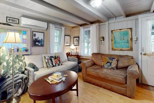 a living room with a couch and a table at Seabreeze Retreat in Oak Bluffs