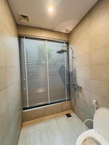 a bathroom with a shower and a toilet at Homestay Ninh Chữ in Thanh Hải