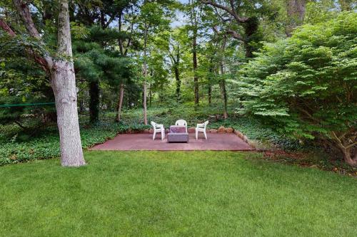 two chairs and a table in the middle of a yard at Beach House in Oak Bluffs
