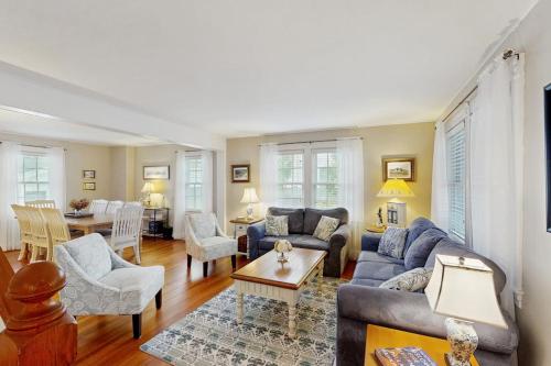 a living room with a couch and a table at Edgartown Village in Edgartown