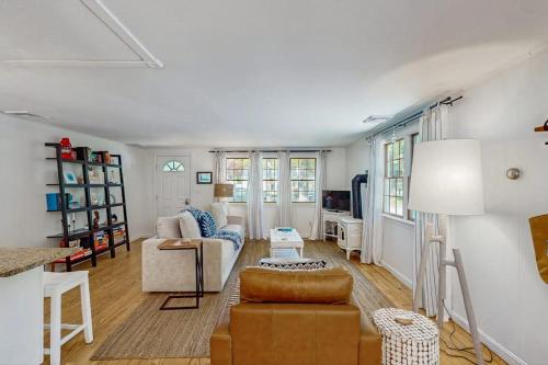 a living room with a couch and a chair at Miles Away in South Dennis