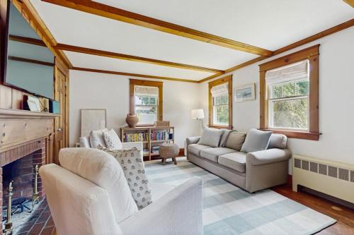 a living room with a couch and a fireplace at The Cygnet in Falmouth