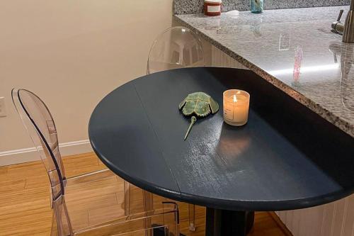 a black table with a candle and a turtle on it at Bayside Beauty in Truro