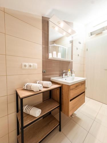 a bathroom with a sink and a mirror at Regina del Mare in Slatine