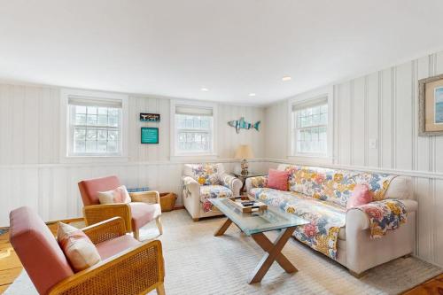 a living room with two couches and a table at Lucky Number Seven in Chatham